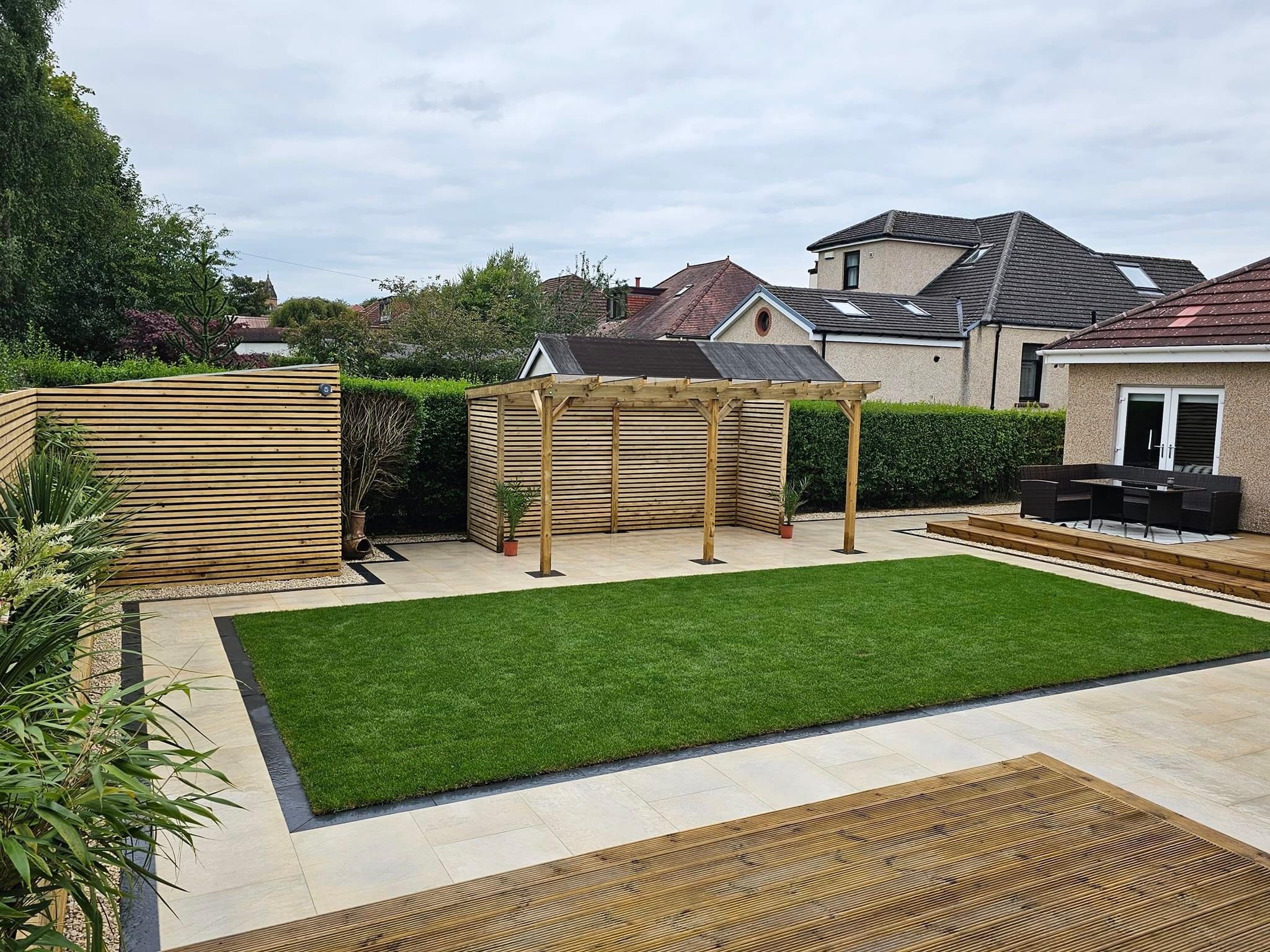 A landscaped garden with a fresh lawn, timber fencing and a paved patio in South Shields