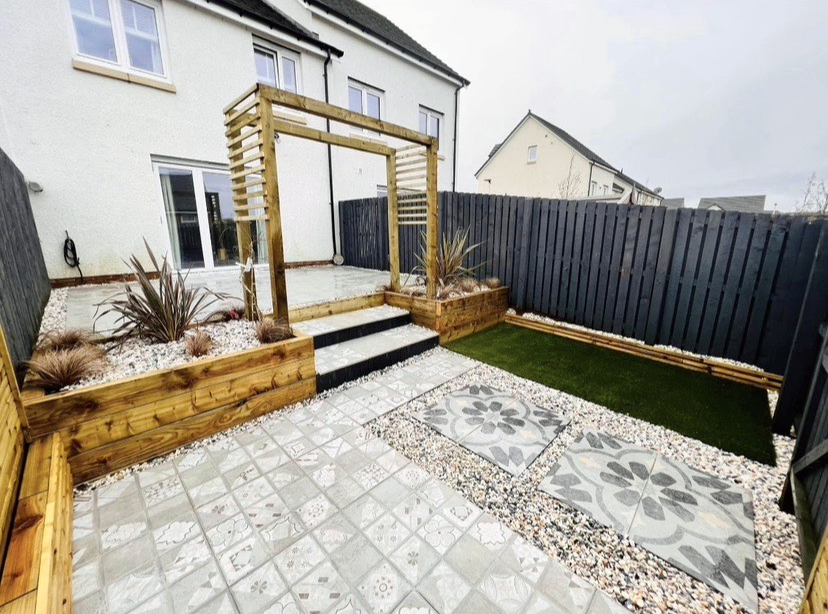 Garden with a timber pergola, paving and gravel borders