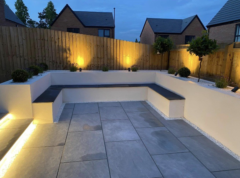 Landscaped garden combining paving, planting and a tidy lawn